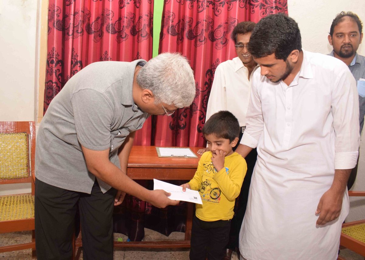 Ashar Dean handing assistance to a young boy and his family