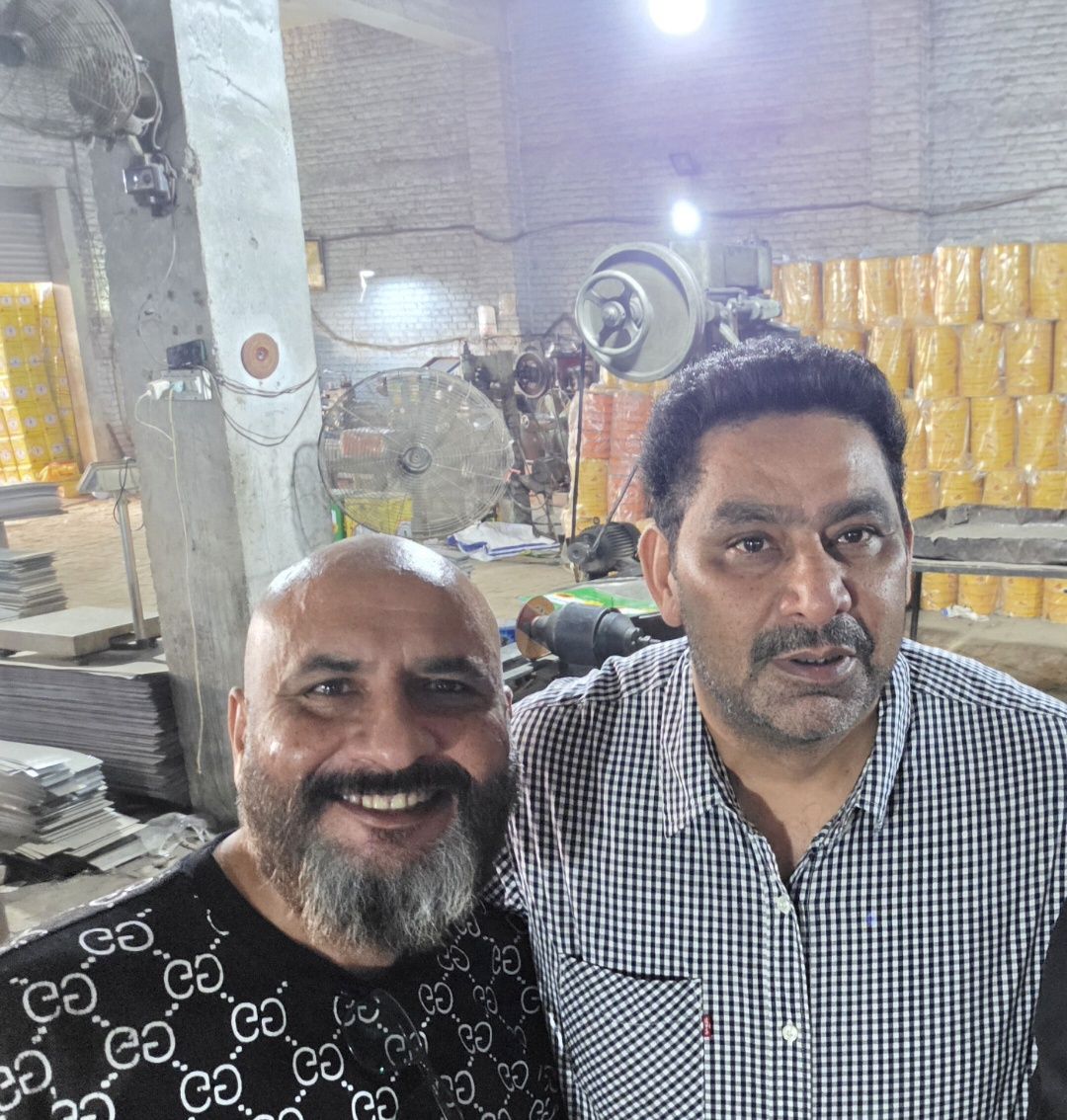 Johnson Lewis with Imran Farooq at his factory in Lahore